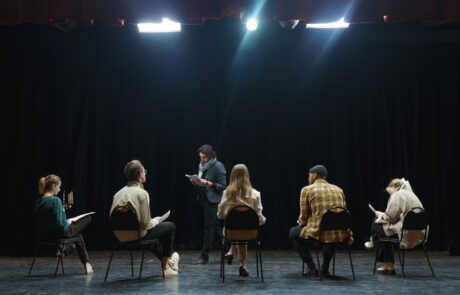 Theatre group studying on stage
