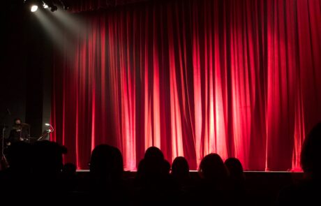 Theatre with red curtains and bright lights